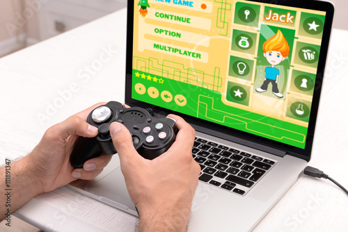 Young man playing computer ...