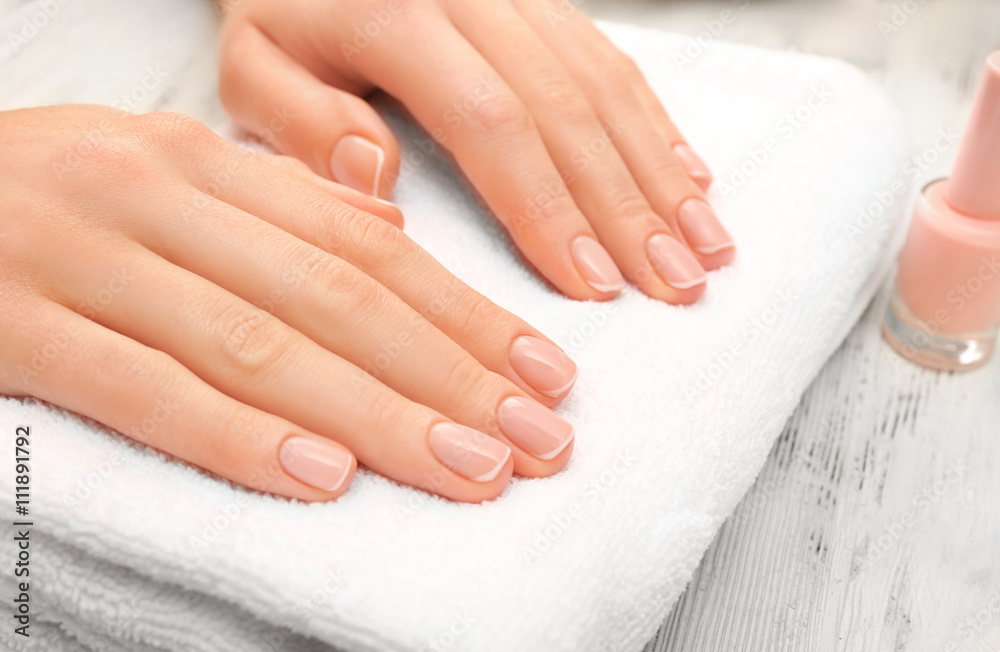 Woman hands with beautiful rose  petals on towel, close up