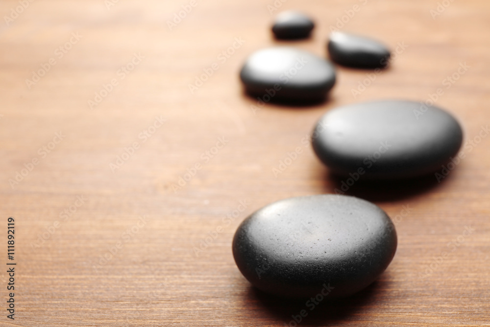 Heap of spa hot stones on wooden background Heap of spa hot stones on wooden background
