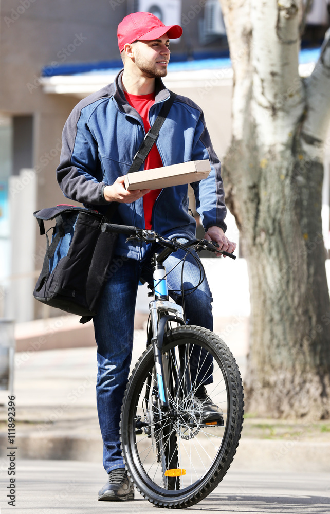Young man with bike delivering pizza Young man with bike delivering pizza