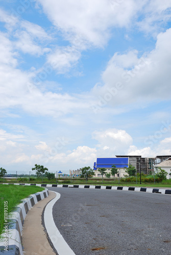 Asphalt road and clouds on blue sky in summer day