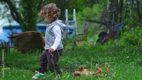 Two Years Old Girl Playing With Puppy
