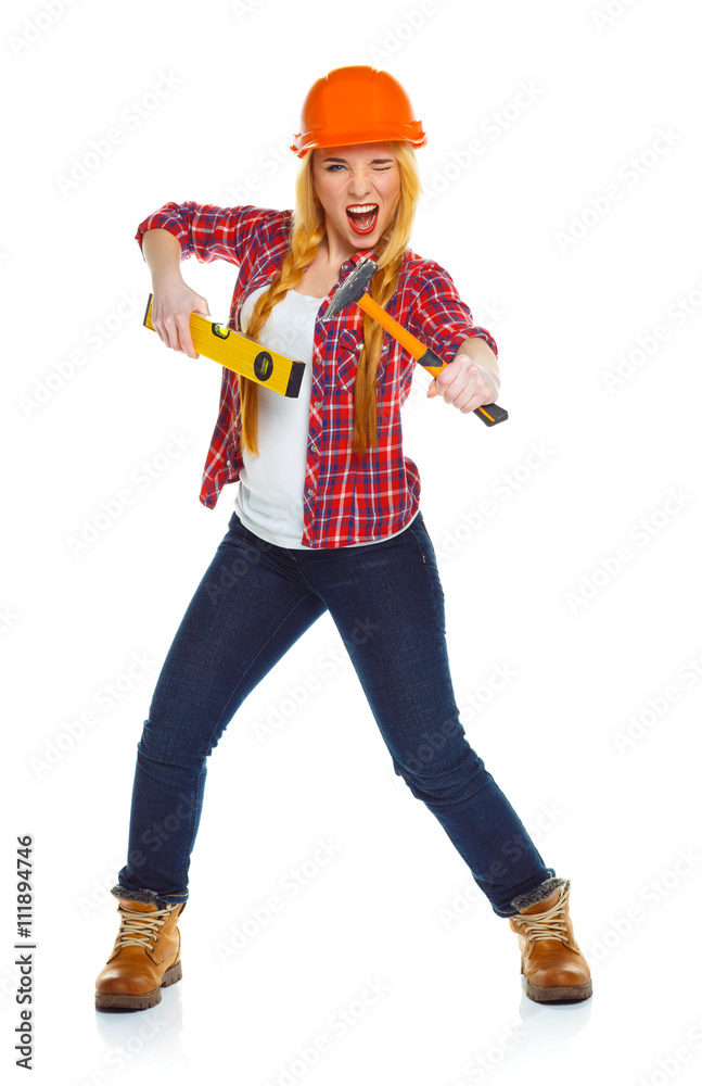 Young woman worker in helmet with the work tools on a white Young woman worker in helmet with the work tools on a white