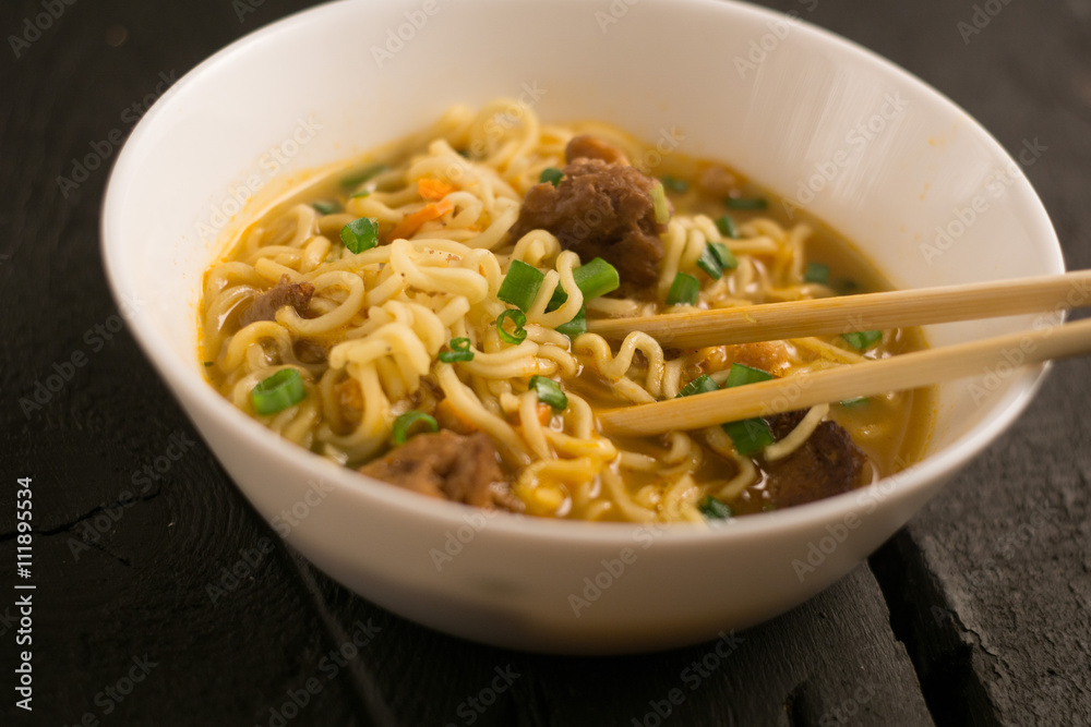 Asian quick noodles on wood with focus and blur background Asian quick noodles on wood with focus and blur background