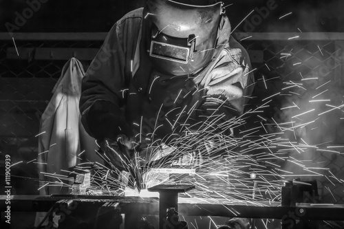 worker with protective mask welding metal