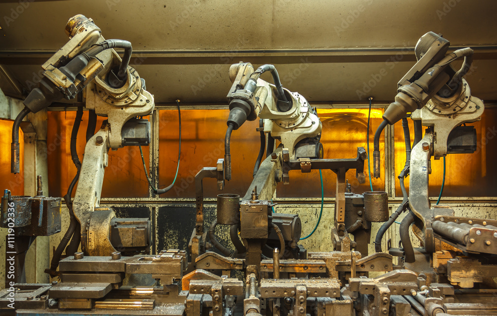 Robots welding team in the automotive