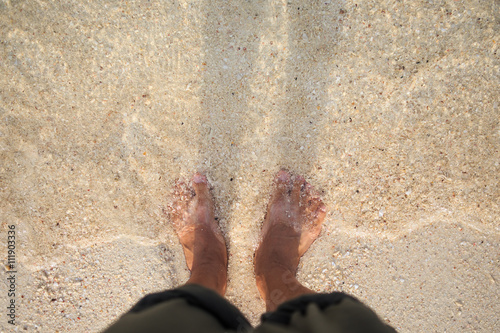 barefoot on clear water beach background