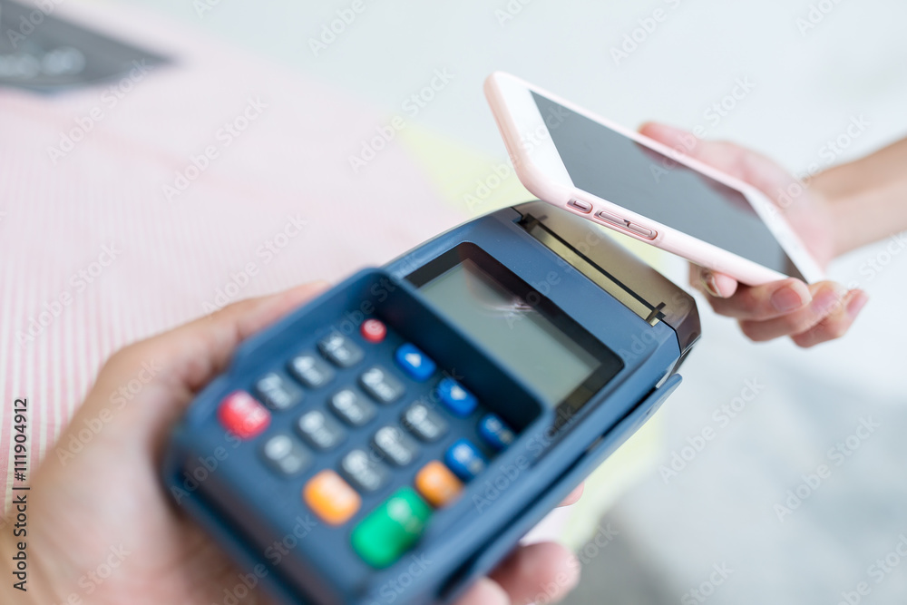 Woman making payment through smartphone Woman making payment through smartphone
