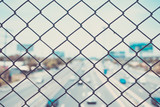 steel wire mesh (mesh fence) with city road highway out focus. vintage photo