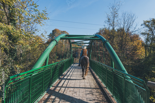 Pretty girl riding her grey horse
