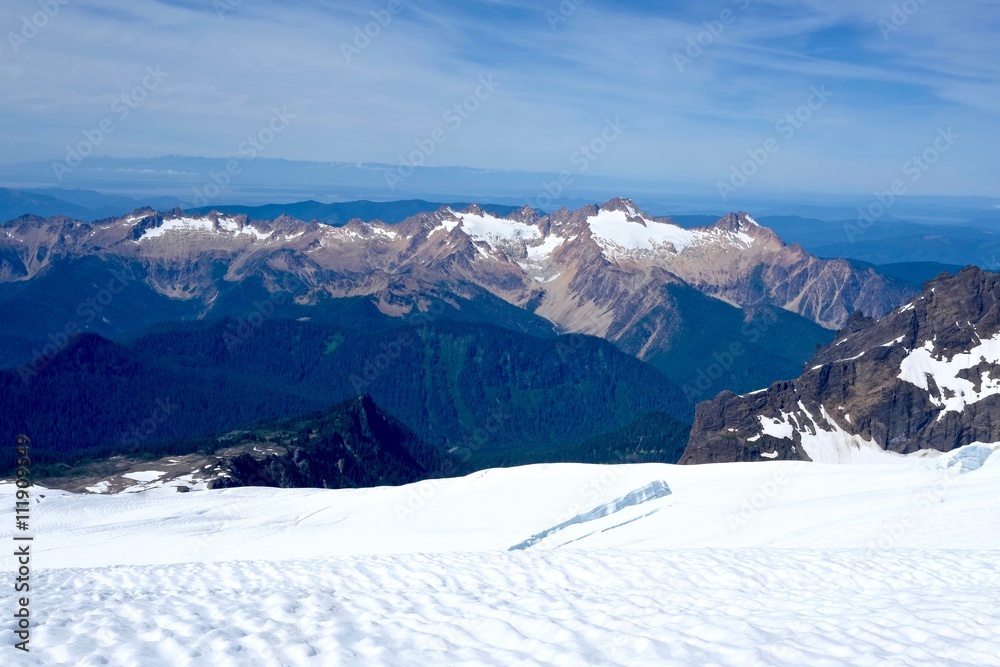 Mountains, Snow, Sky and Clouds. Breathtaking view from Mount Baker summit,  North Cascades National Park, Washington State, USA. 