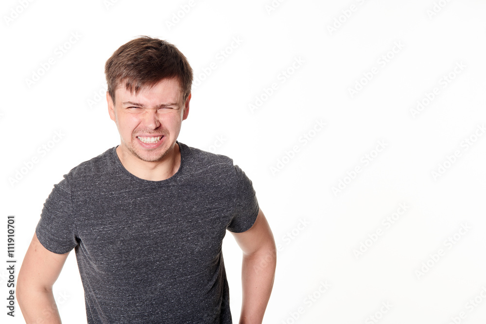 Cringing young man with light beard, isolated on white, with space for text Cringing young man with light beard, isolated on white, with space for text