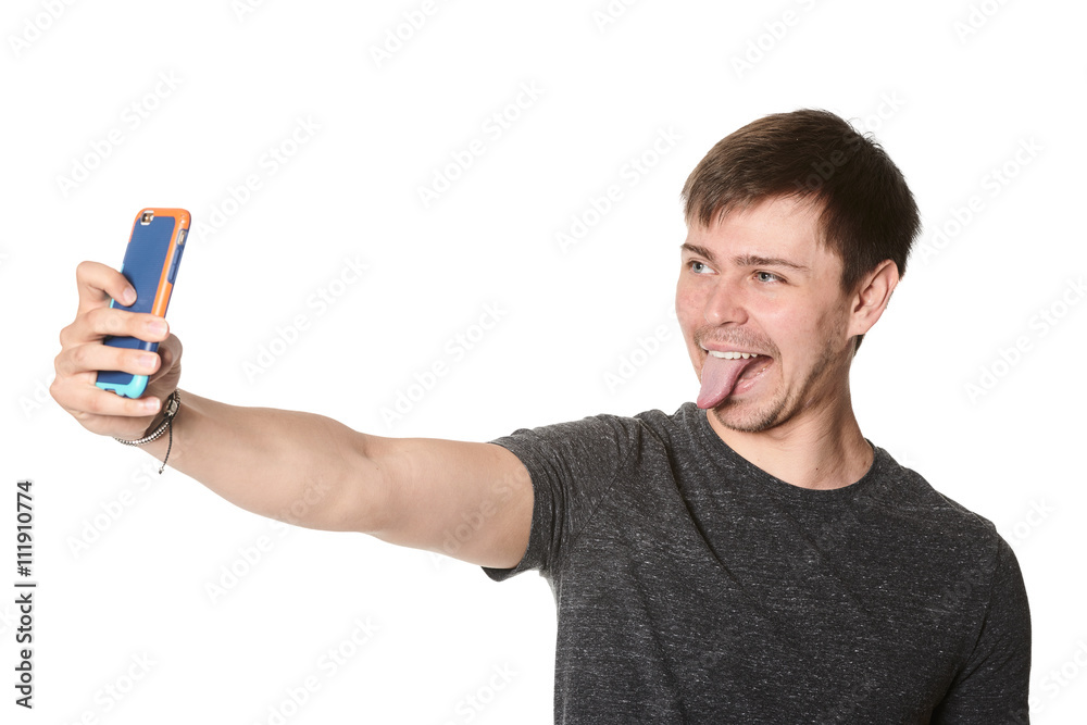 Casual young man with light beard, taking selfie on mobile phone, isolated on white Casual young man with light beard, taking selfie on mobile phone, isolated on white