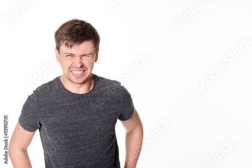 Cringing young man with light beard, isolated on white, with space for text