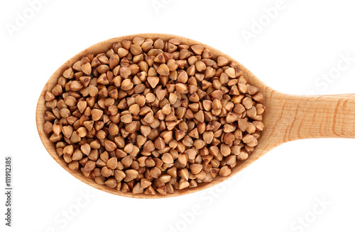Wooden spoon with buckwheat isolated on white background.