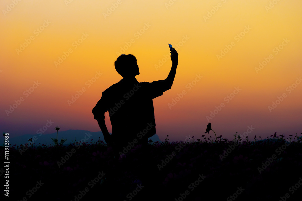 Silhouette of man selfie. Silhouette of man posing at sunset sky background.