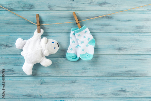 White toy bear and baby socks with stars print on a clothesline