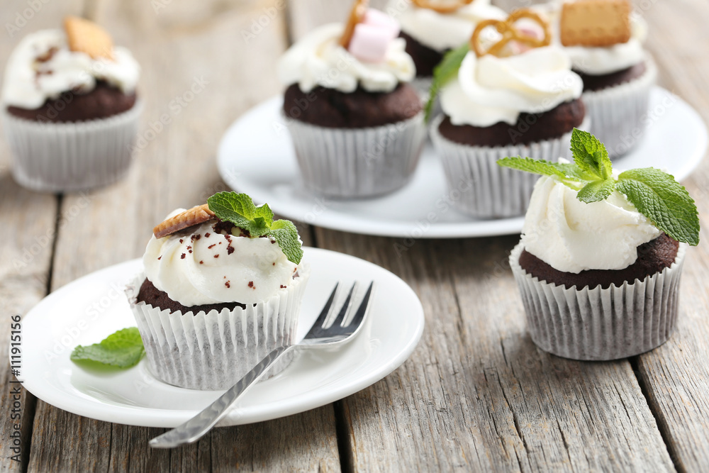 Chocolate cupcakes on a grey wooden table Chocolate cupcakes on a grey wooden table