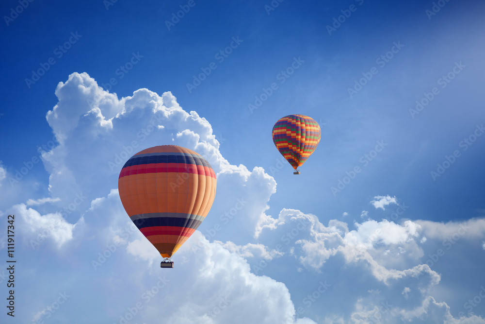 Fototapeta premium Hot air balloons flies in blue sky
