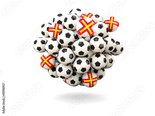 Pile of footballs with flag of guernsey