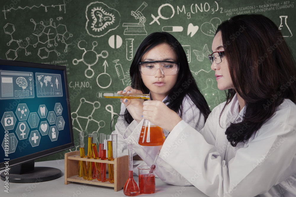 Female students mix the chemical fluid Female students mix the chemical fluid