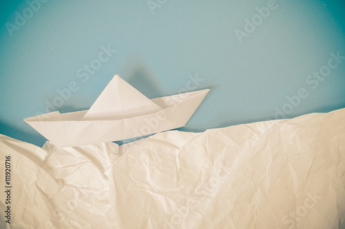 paper boat on blue background