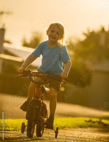 smiling child on a bike