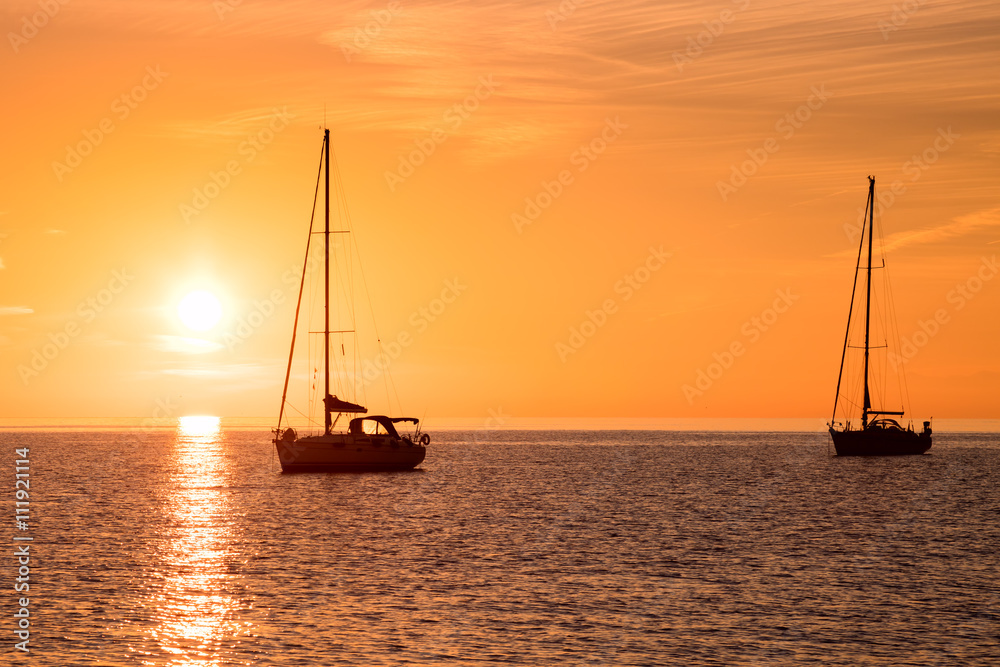 Yachts in the sea at sunset
