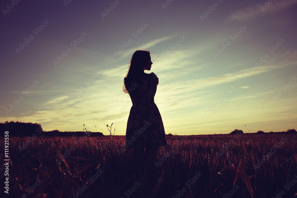 Girl in the field on sky background sunset Stock Photo | Adobe Stock