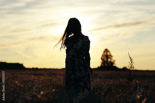 Canvas Print girl in the sunset cloudy sky Field