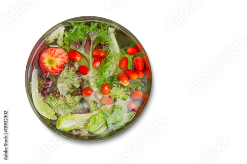 Washing fresh vegetables in the water in the metal bowl on white background