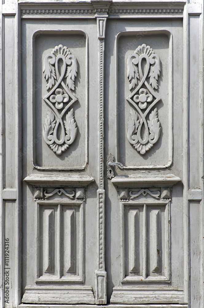 Old vintage wooden white door with floral patterns. Grodno, Belarus.