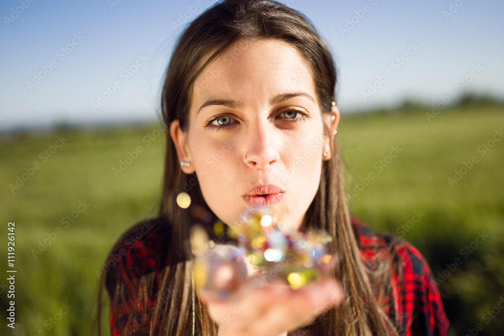 Beautiful young woman enjoying spring in a field.