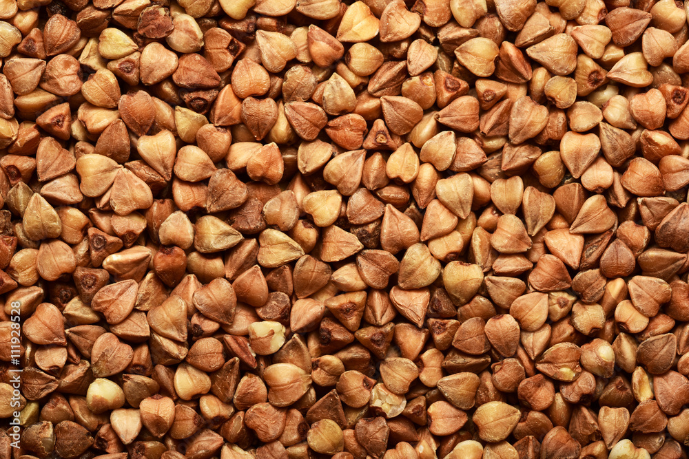 Sun lighted buckwheat grain seeds closeup background Sun lighted buckwheat grain seeds closeup background