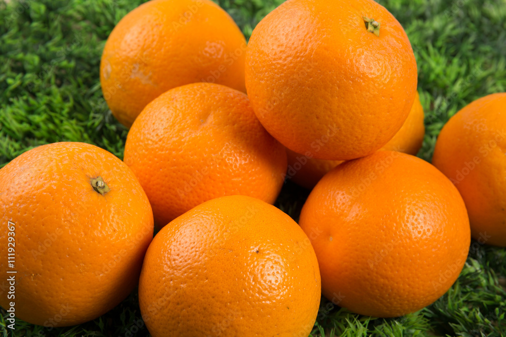 Lots of Fresh orange fruits on green grass Lots of Fresh orange fruits on green grass