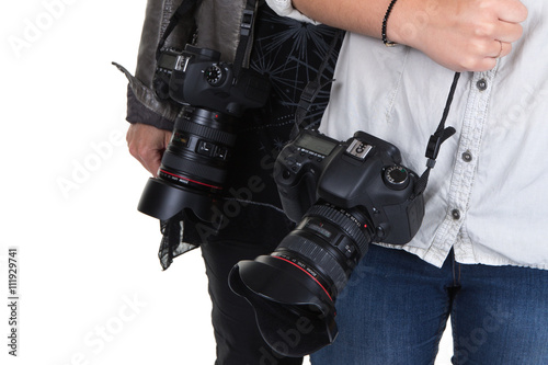 Image of two women holding camera in studio