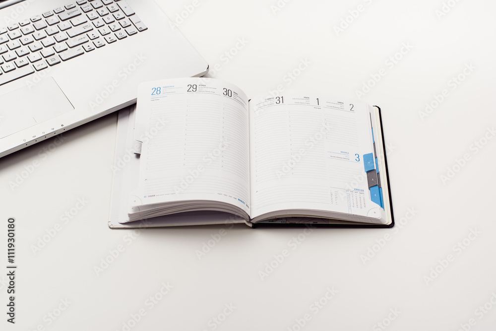 Top view of creative drawing or writing theme concept. Notepad or vintage callendar and crumpled paper on white, wooden table background. Top view of creative drawing or writing theme concept. Notepad or vintage callendar and crumpled paper on white, wooden table background.