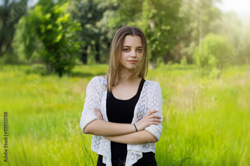 Portrait of a female teenager standing in the park