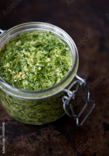 Homemade parsley and basil pesto in a jar