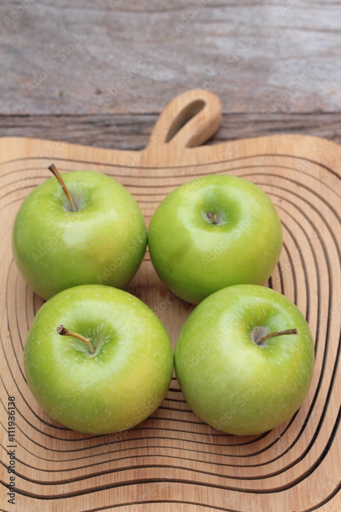 green apples is delicious on wood background. green apples is delicious on wood background.