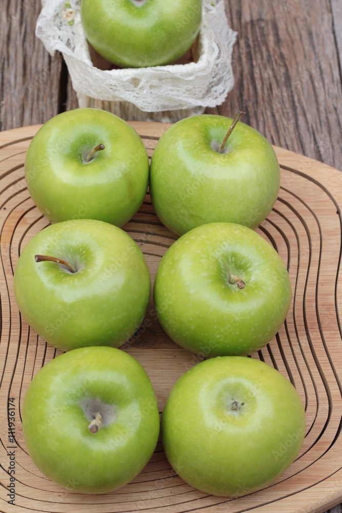 green apples is delicious on wood background. green apples is delicious on wood background.