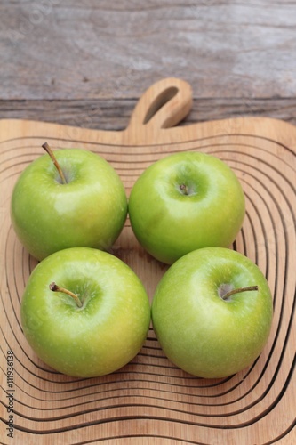 green apples is delicious on wood background.