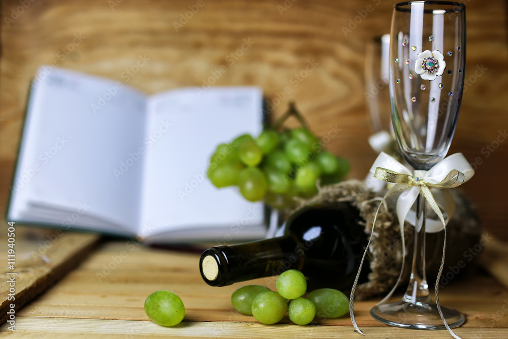 Obraz premium wine bottle book and glass grape