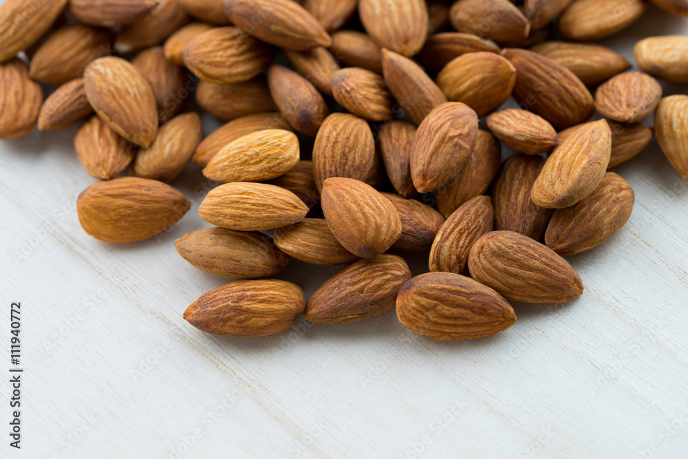 almonds on wooden background almonds on wooden background