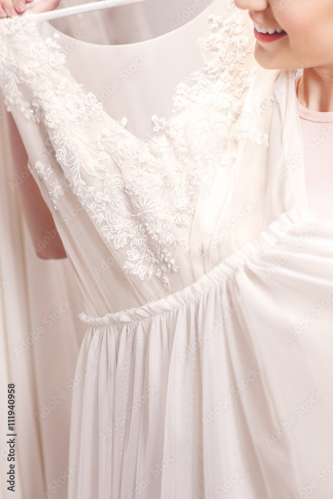 Beautiful young woman is buying bridal clothing Beautiful young woman is buying bridal clothing