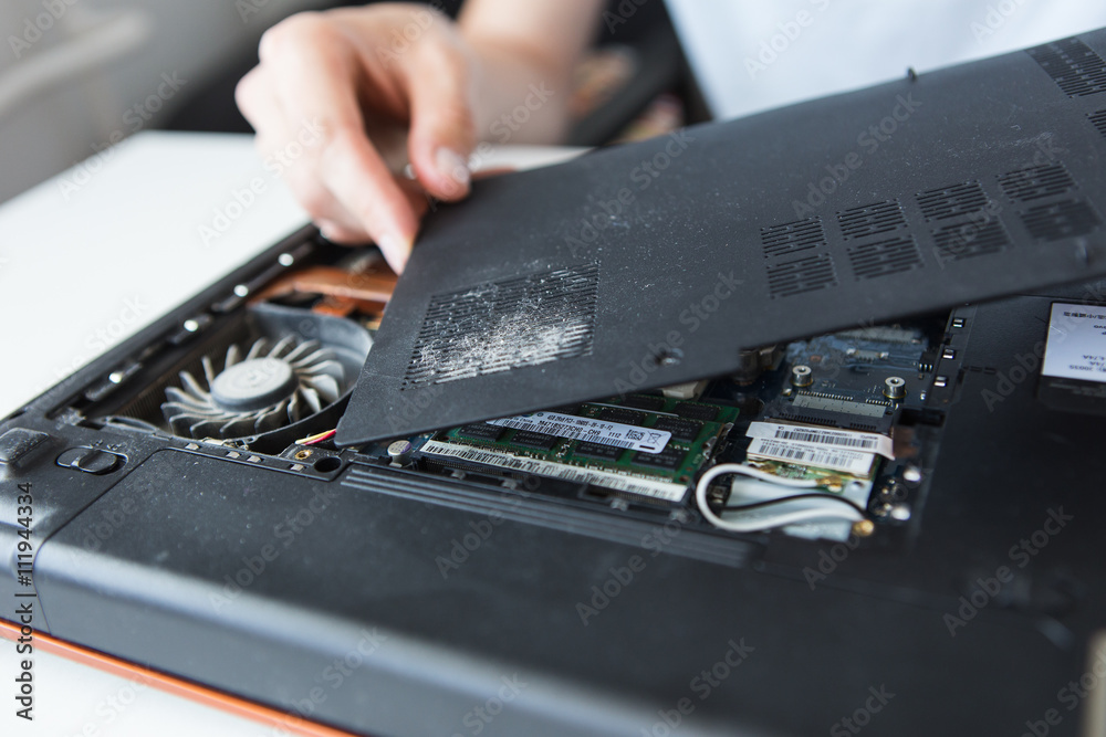 Computer literacy repair men hands, cooling, the hot temperature of the laptop, fan, dust pollution Computer literacy repair men hands, cooling, the hot temperature of the laptop, fan, dust pollution