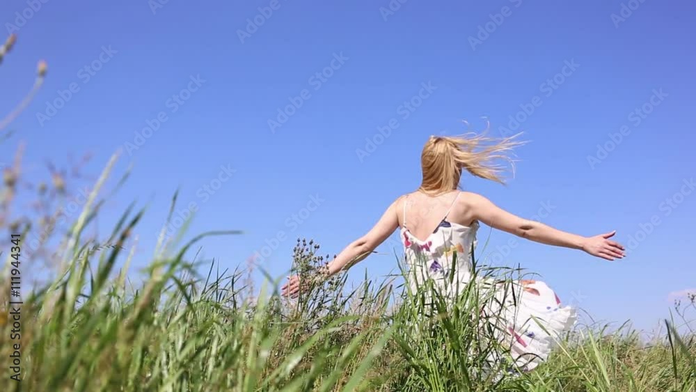 happy woman turning around itself in a field until falling happy woman turning around itself in a field until falling