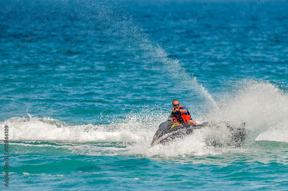 Young Man on Jet Ski, Tropical Ocean, Vacation Concept Young Man on Jet Ski, Tropical Ocean, Vacation Concept