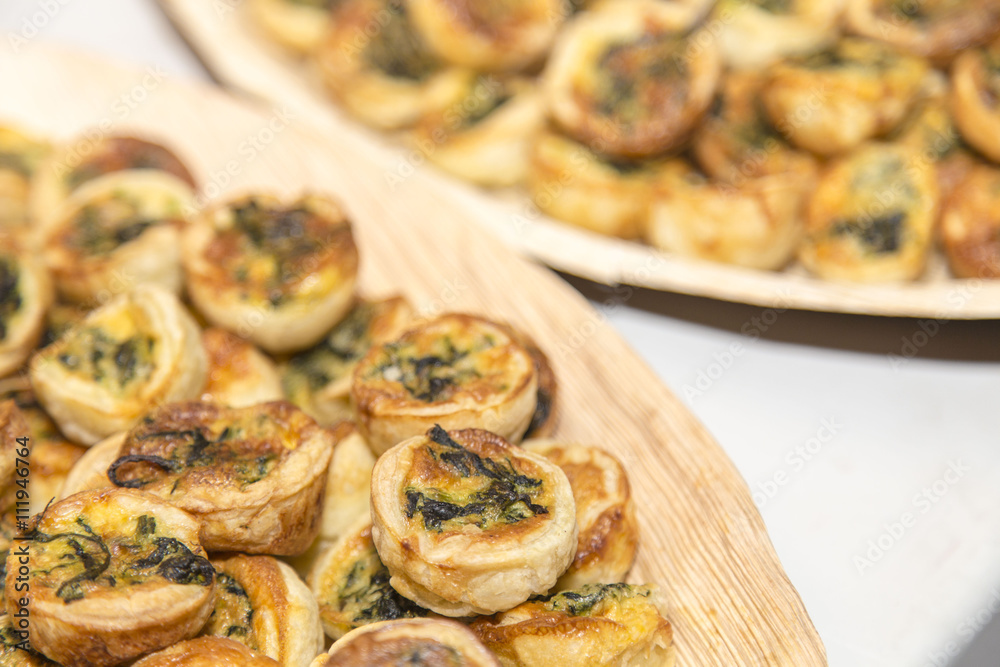 Vegetables pastry small tarts on plates on appetizer catering restaurant