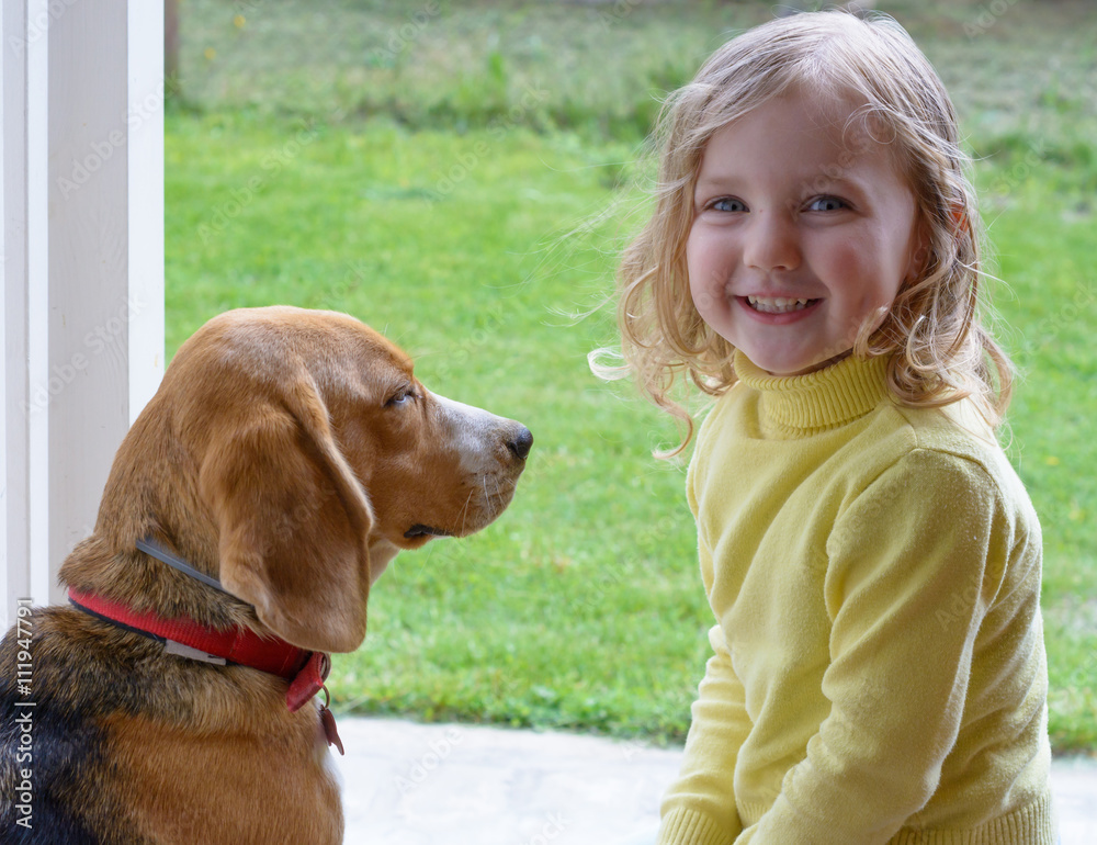 Young cute girl with dog playing in garden Young cute girl with dog playing in garden